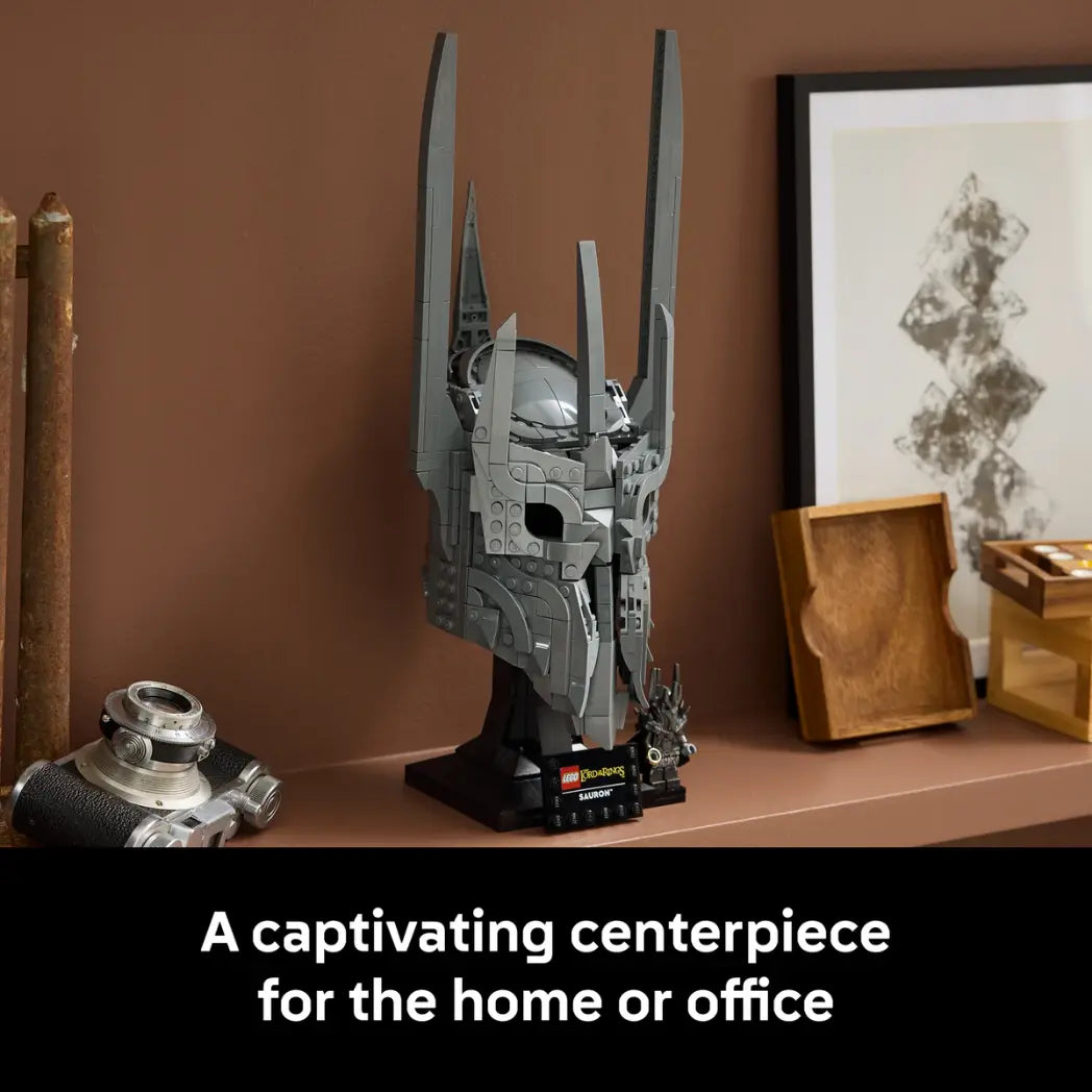Built Lego Sauron Helmet displayed on a shelf alongside a vintage camera and wooden decor items.