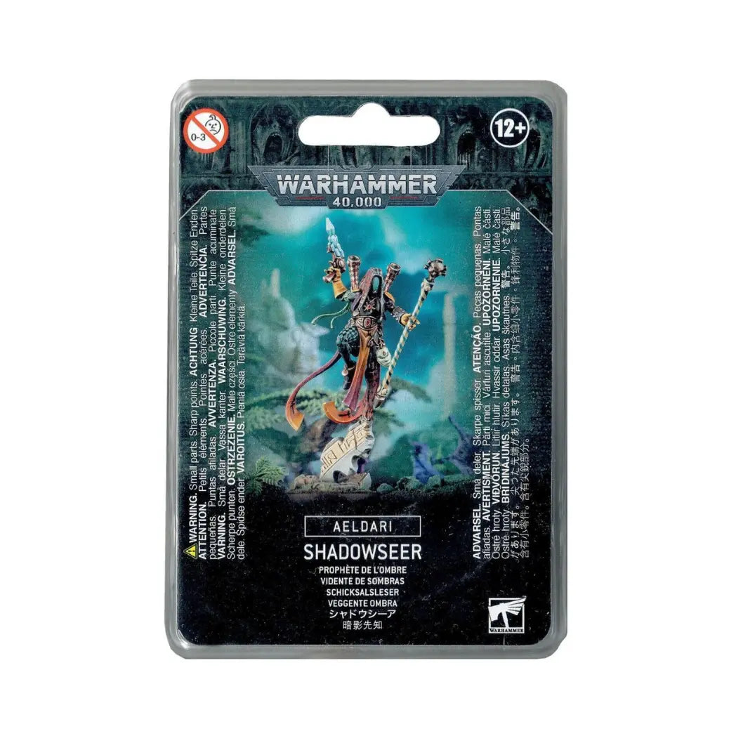 Aeldari Shadowseer blister pack featuring a hooded Harlequin in colorful robes, holding a staff and a shuriken pistol.
